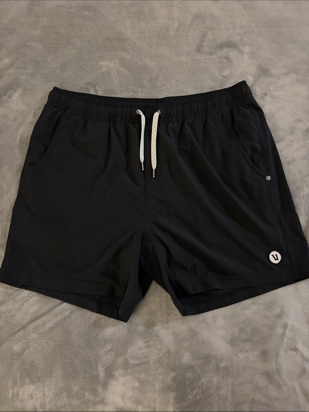 Vuori Men's Black Athletic Swim Shorts with Drawstring and Subtle Logo.